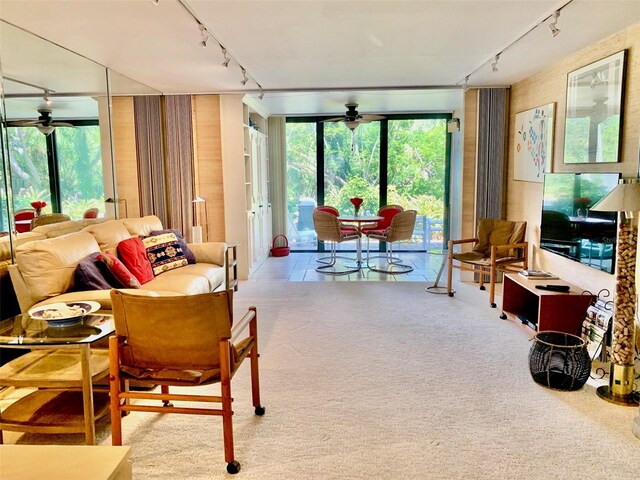 carpeted living room featuring ceiling fan