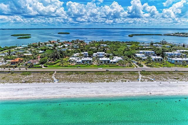 birds eye view of property with a water view and a view of the beach