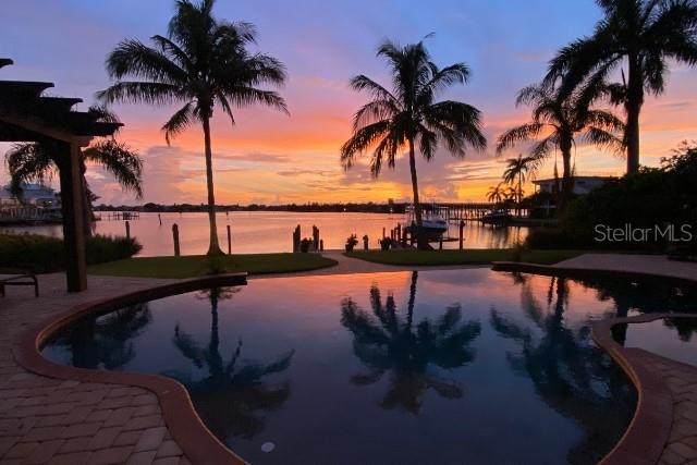 pool at dusk with a water view