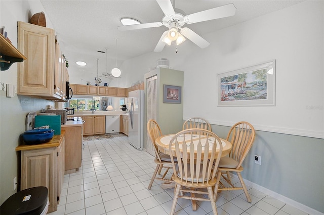 dining room with light tile flooring and ceiling fan