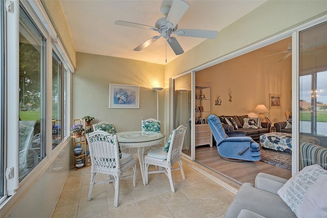 sunroom featuring ceiling fan