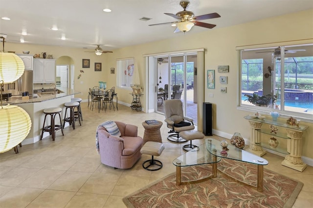 tiled living room with sink and ceiling fan