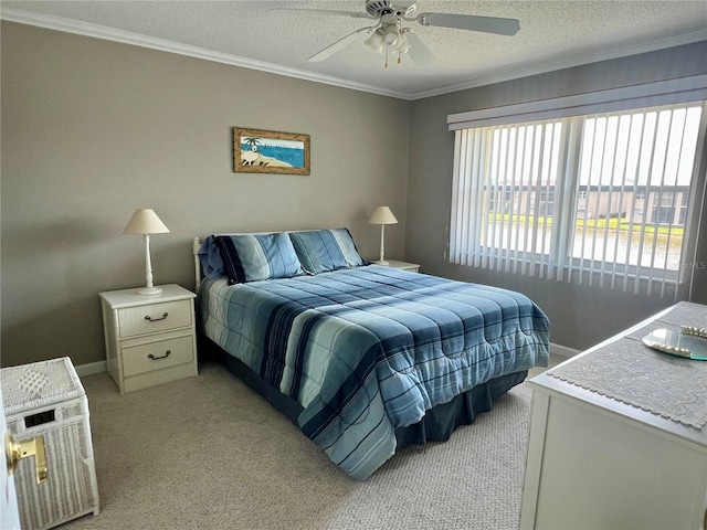 carpeted bedroom featuring ceiling fan, crown molding, and a textured ceiling