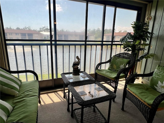 sunroom / solarium featuring a water view