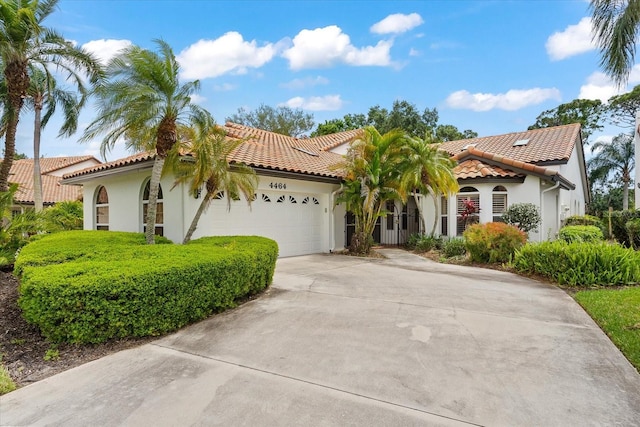 mediterranean / spanish-style house with a garage