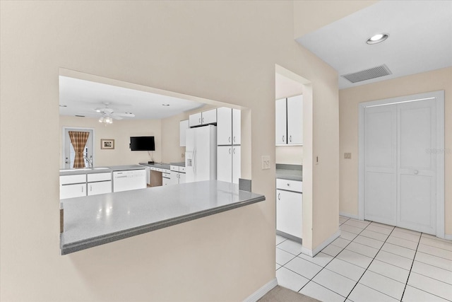 kitchen featuring light tile flooring, ceiling fan, white appliances, and white cabinetry