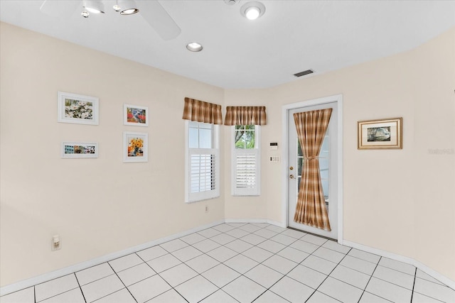 tiled empty room with ceiling fan