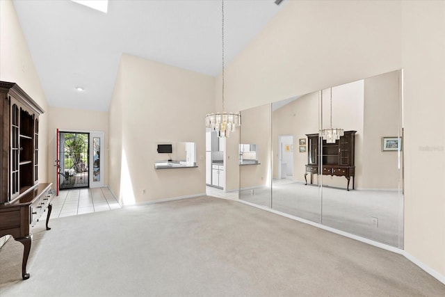 living room featuring a notable chandelier, high vaulted ceiling, and light carpet