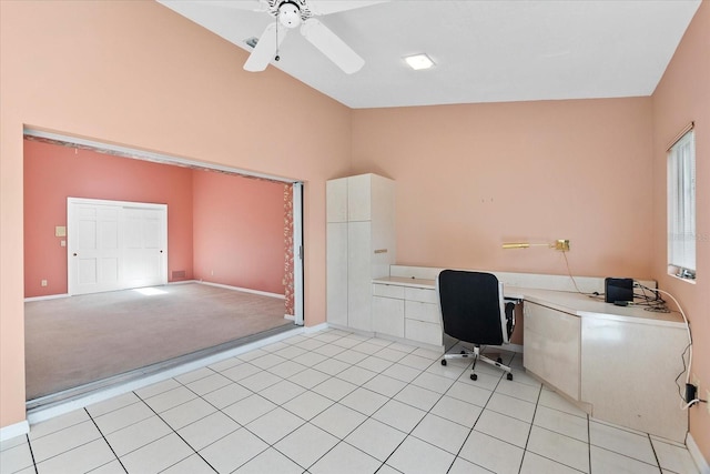 unfurnished office featuring light carpet, ceiling fan, and vaulted ceiling