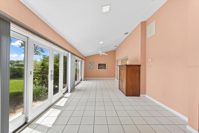 interior space with light tile floors and lofted ceiling