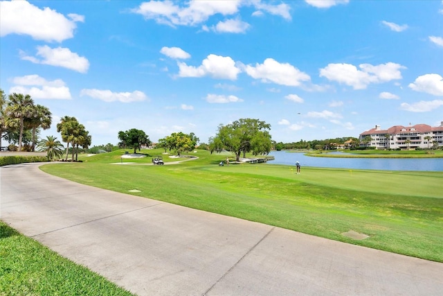 view of home's community featuring a lawn and a water view