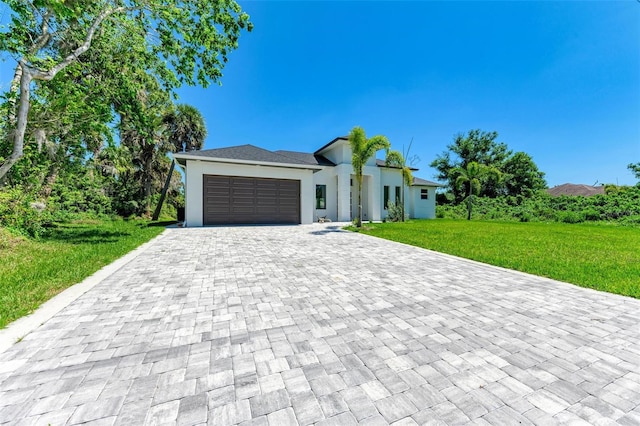 view of front of home with a front yard and a garage