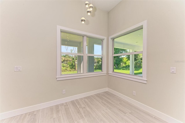 unfurnished room with a notable chandelier