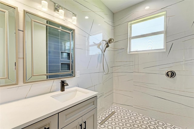 bathroom with vanity and a tile shower