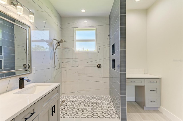 bathroom featuring tile floors, vanity, and tiled shower