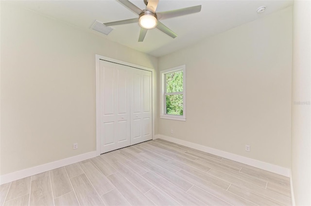 unfurnished bedroom with a closet, ceiling fan, and light wood-type flooring