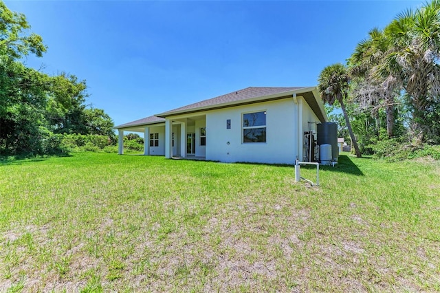 rear view of property featuring a yard