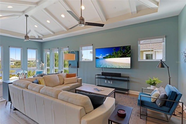 living room with hardwood / wood-style floors, ceiling fan, and vaulted ceiling with beams