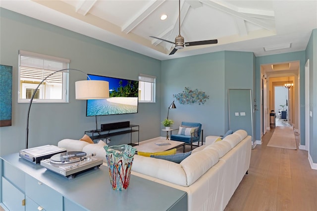 living room with beamed ceiling, light wood-type flooring, and ceiling fan