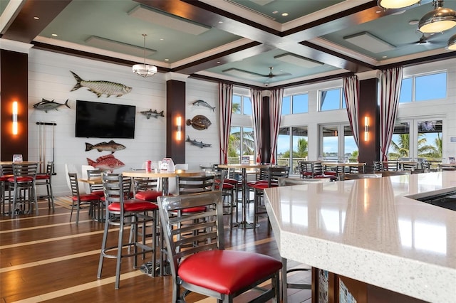 bar featuring a wealth of natural light, dark hardwood / wood-style flooring, ceiling fan, and coffered ceiling