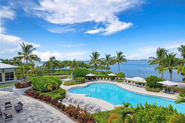 view of swimming pool featuring a patio area and a water view