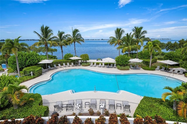 view of swimming pool with a water view and a patio