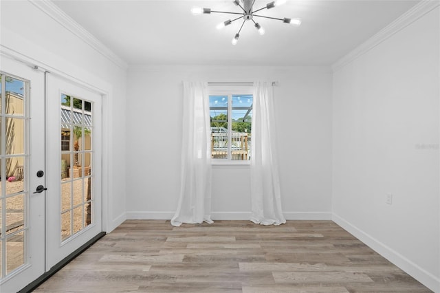 unfurnished room with crown molding, light wood-type flooring, french doors, and plenty of natural light