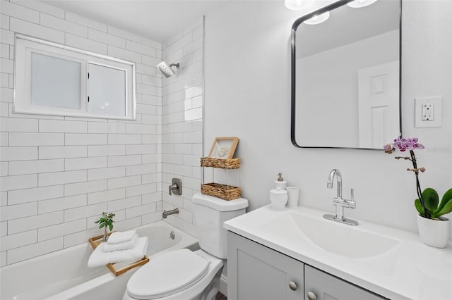 full bathroom with toilet, tiled shower / bath combo, and vanity