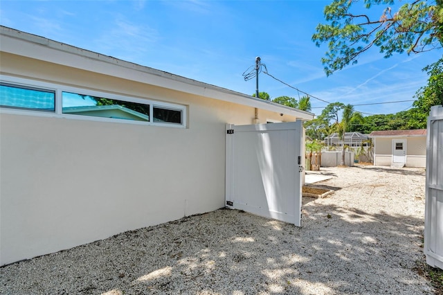 view of side of property featuring a shed