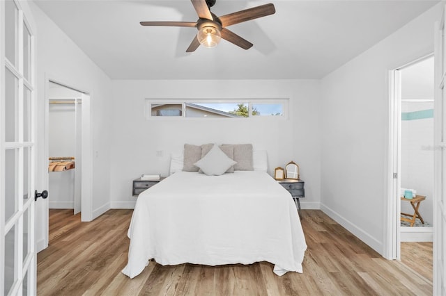 bedroom with light hardwood / wood-style flooring, a closet, and ceiling fan