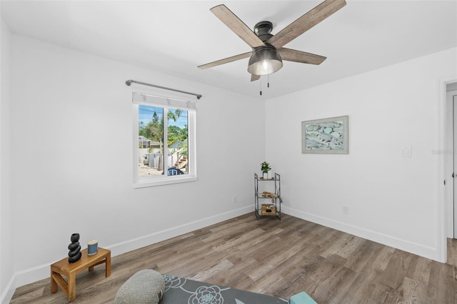 living area with ceiling fan and light wood-type flooring