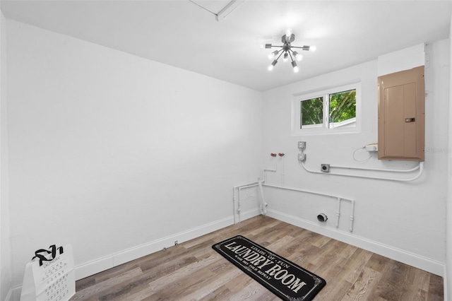 washroom with light hardwood / wood-style flooring, electric panel, and washer hookup