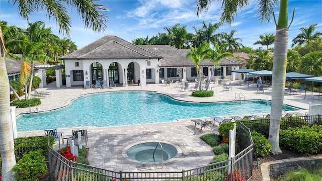 view of pool with a community hot tub and a patio area