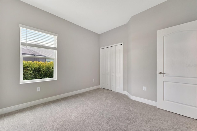 unfurnished bedroom with carpet and a closet