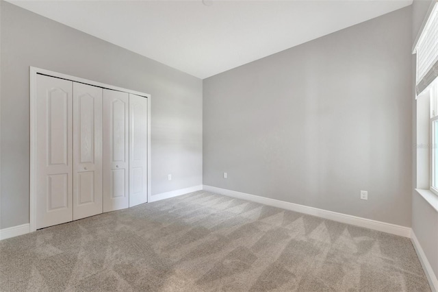 unfurnished bedroom with carpet flooring and a closet