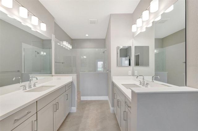 bathroom featuring tile patterned flooring, vanity, and tiled shower