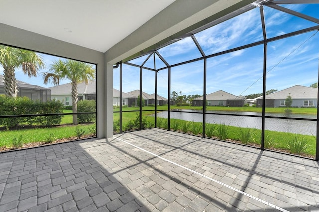 unfurnished sunroom with a water view