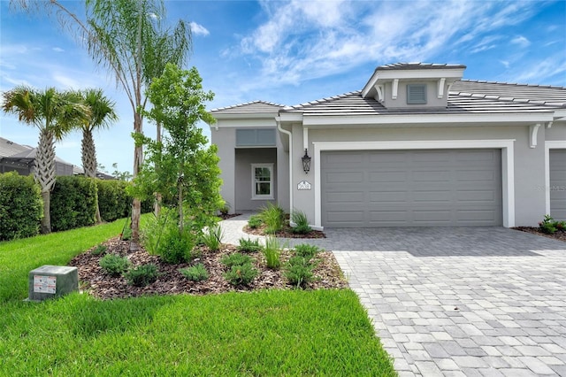 view of front of property featuring a garage and a front lawn