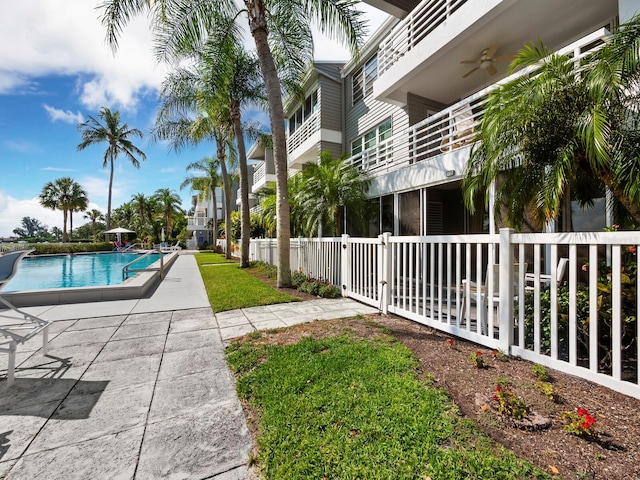 view of pool with a patio and ceiling fan