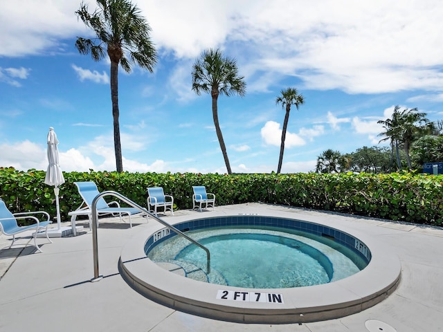 view of swimming pool with a patio and a hot tub