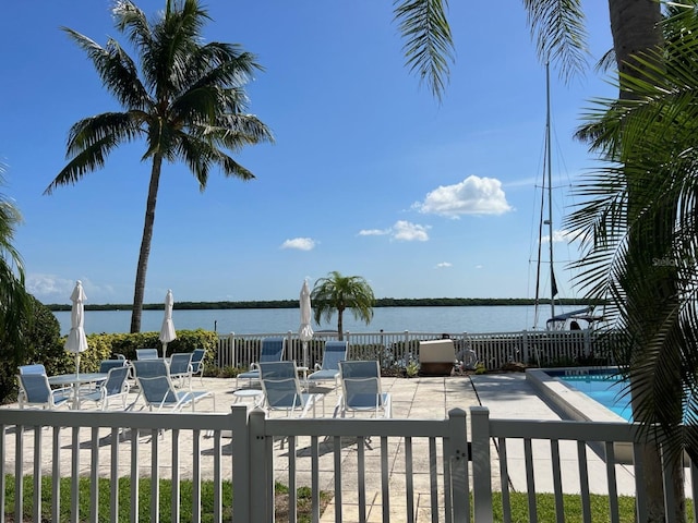 view of patio featuring a community pool and a water view