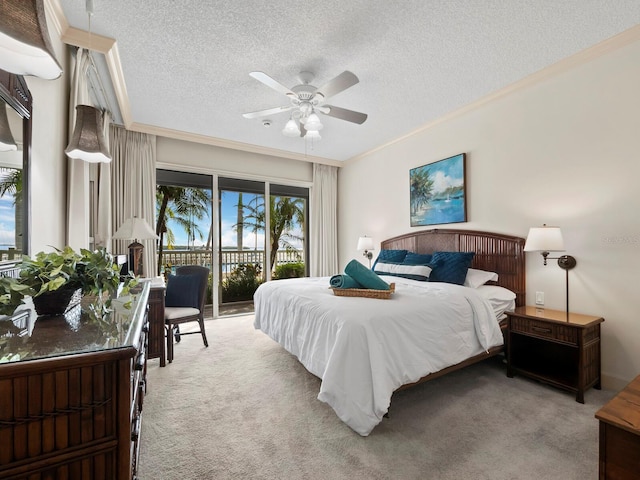 carpeted bedroom with a textured ceiling, access to outside, ceiling fan, and crown molding