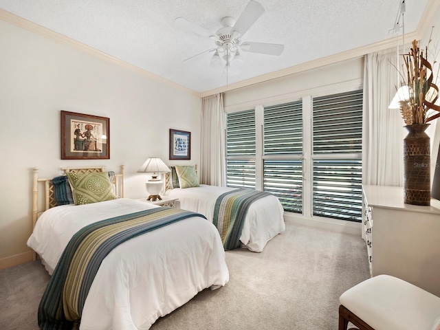 bedroom with carpet flooring, ceiling fan, ornamental molding, and a textured ceiling