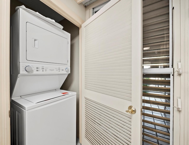 washroom featuring stacked washing maching and dryer