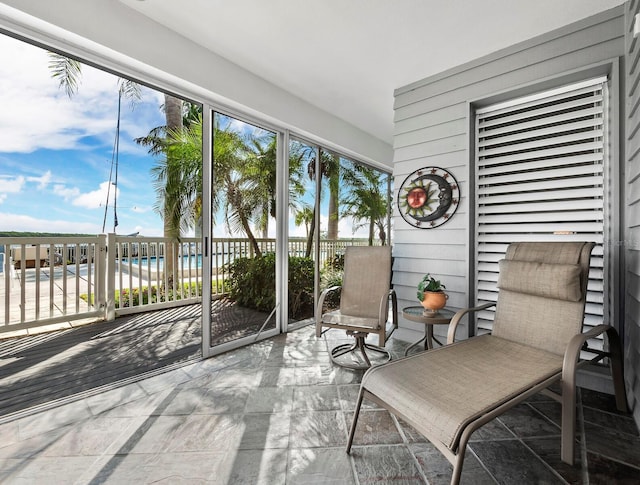 sunroom / solarium with a water view