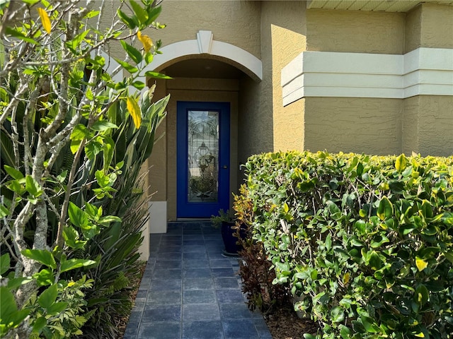 entrance to property with stucco siding