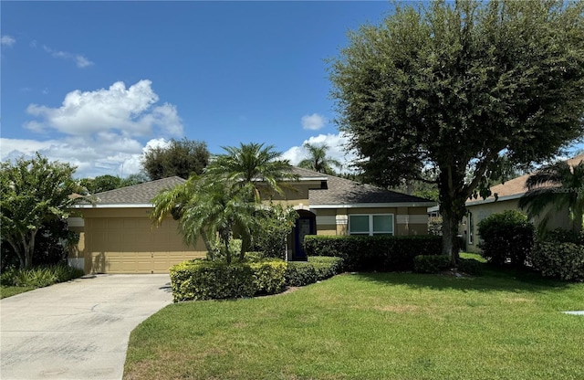 view of front facade with a front yard and a garage