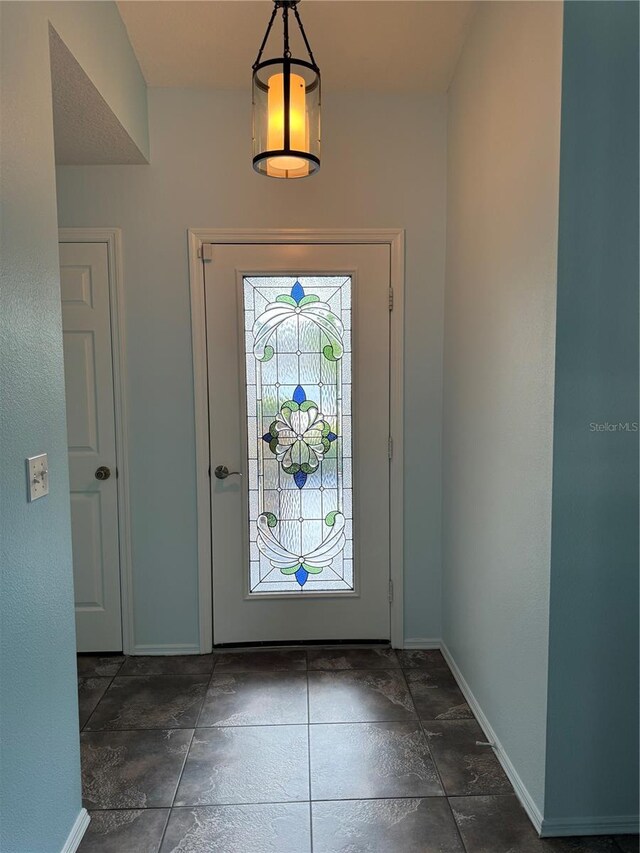 entrance foyer featuring dark tile patterned flooring