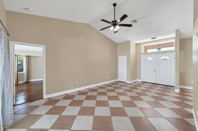 entrance foyer featuring light tile floors, high vaulted ceiling, and ceiling fan