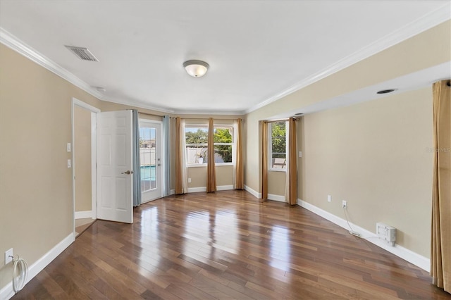 empty room with dark hardwood / wood-style floors and ornamental molding